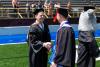 Paul Bascobert shaking hand of recent Kettering graduate