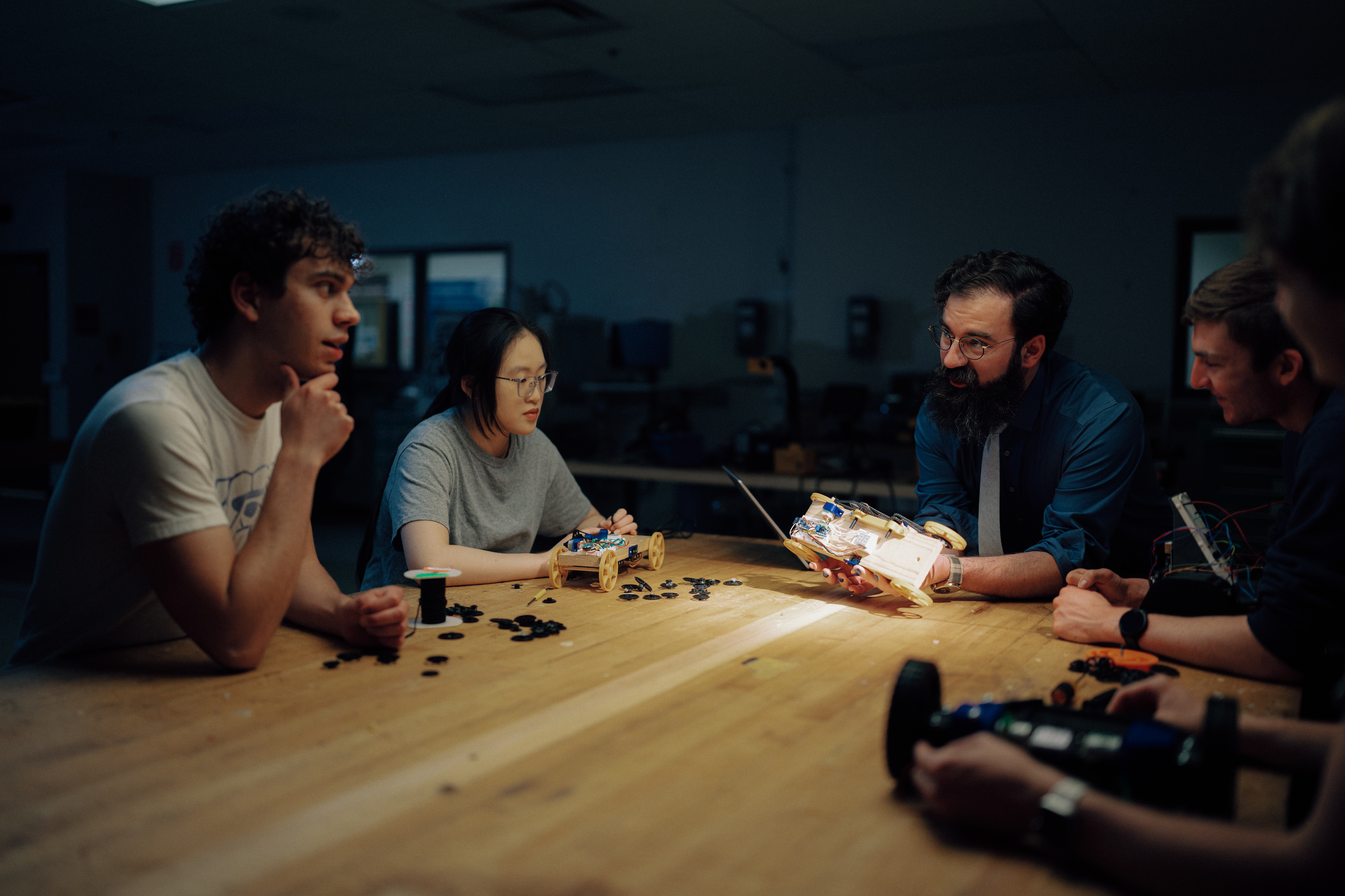 students sitting around a table with professor