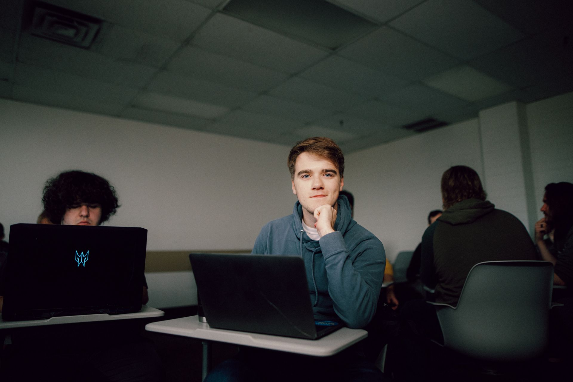 Kettering Lean Principles for Healthcare Certificate student working on a laptop in a classroom, looking up from studies