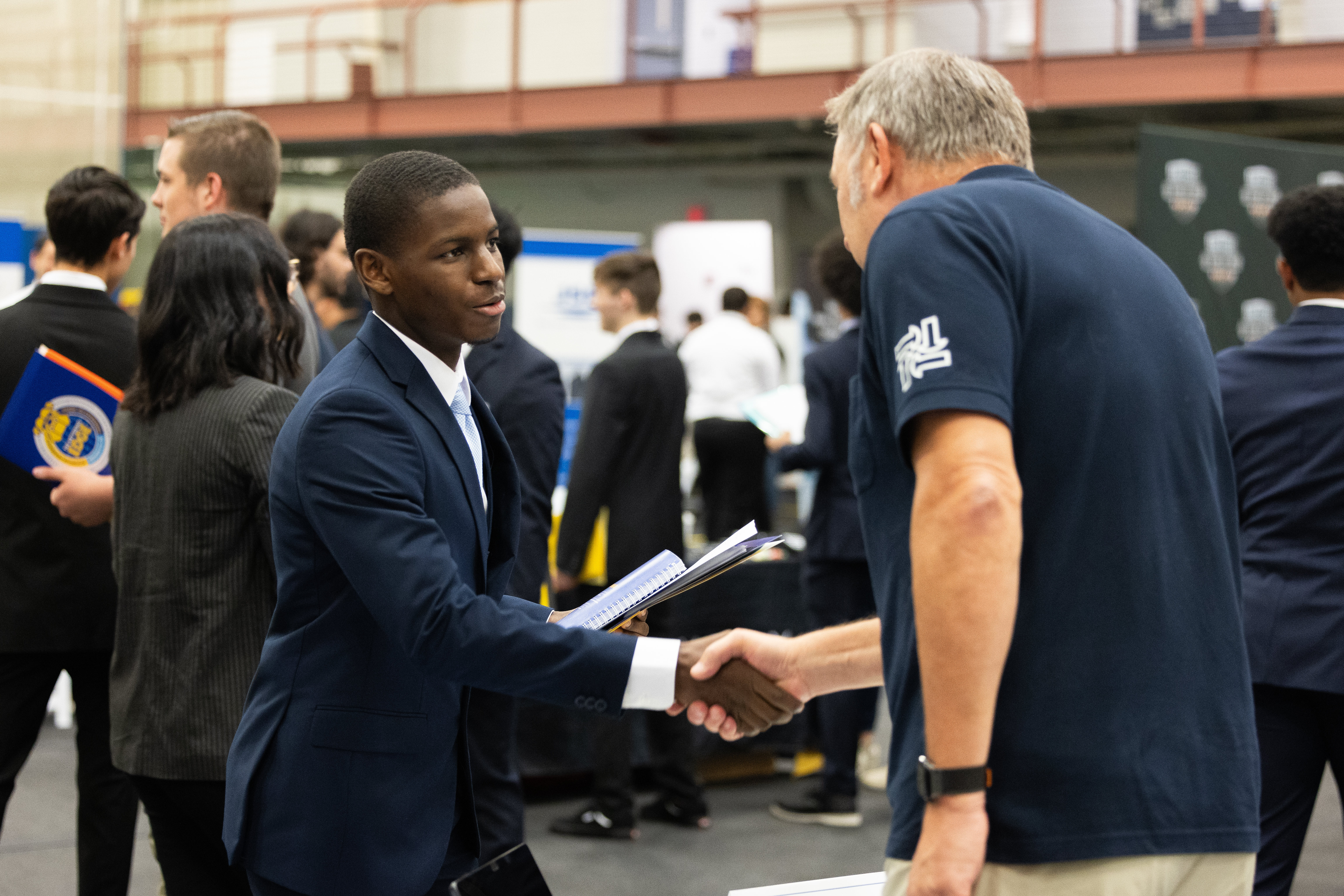 Student shaking employers hand