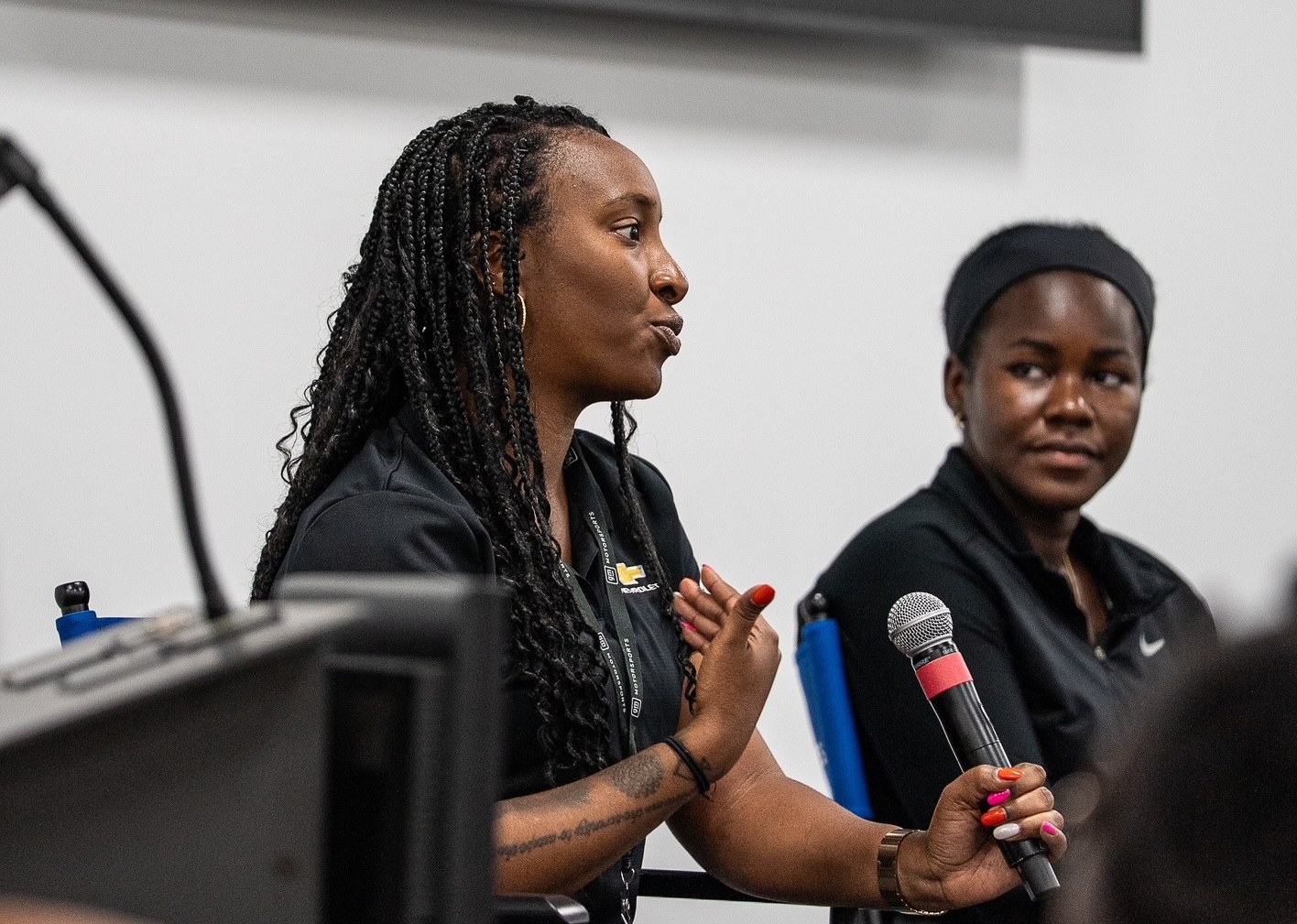 TaiJaune Robinson speaks to a group about her experience as an Engineering Business Manager for GM Motorsports