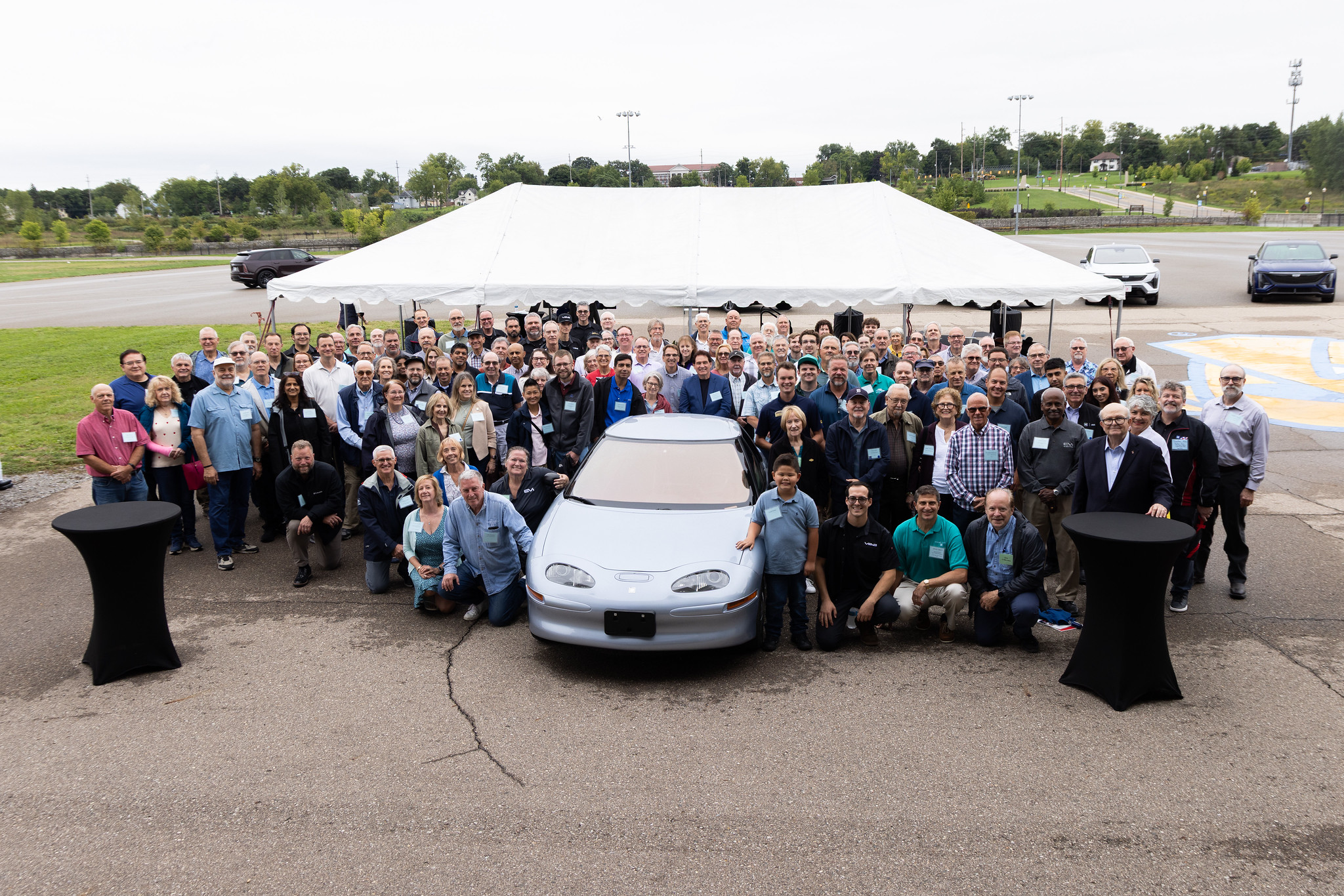 The EV1 Team Poses with Kettering University's EV1 vehicle on the GM Mobility Research Center.