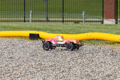 A mini IVD car races at the Square One IVD Competition at Kettering University's GM Mobility Research Center.