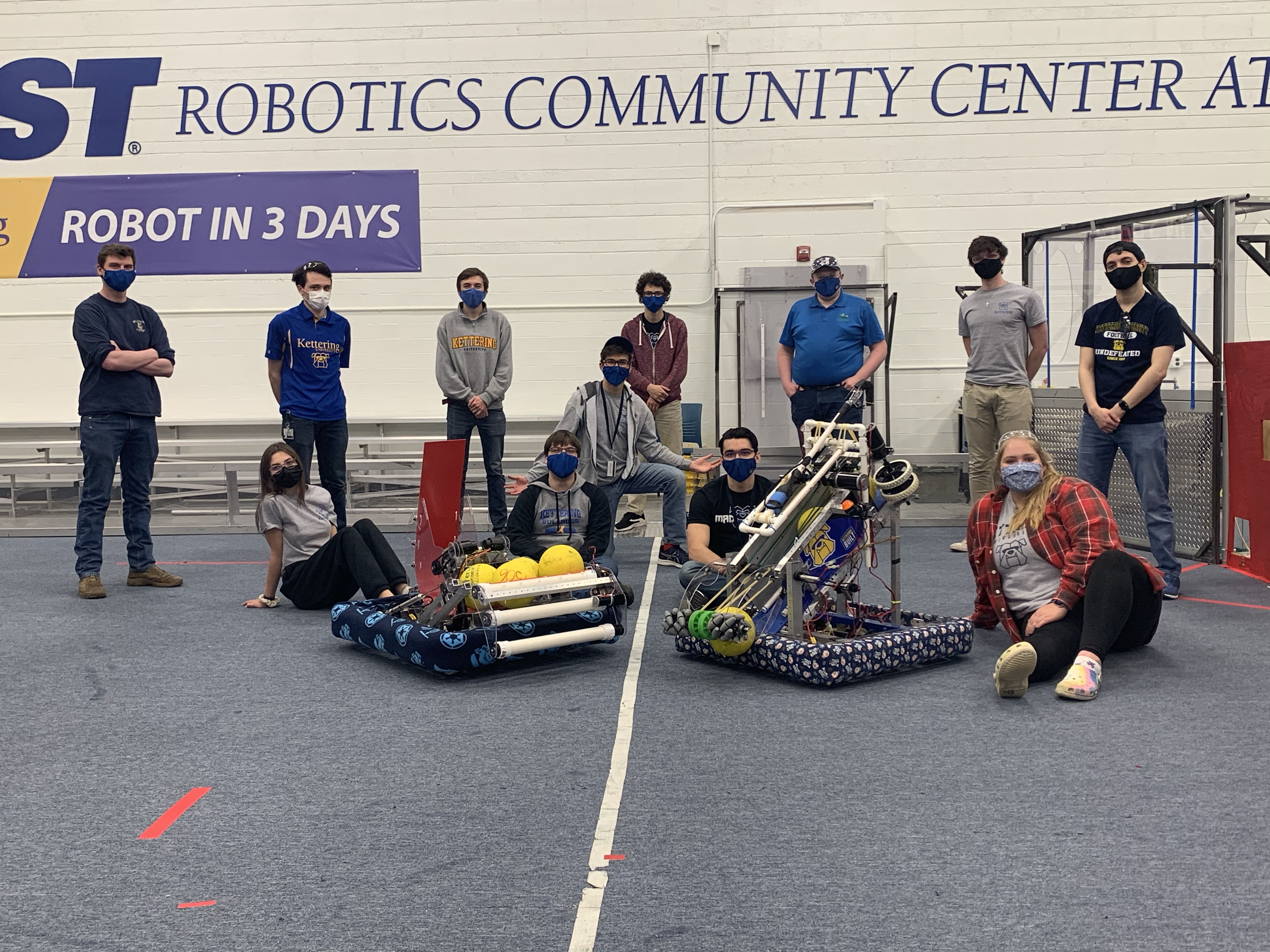 Kettering University students pose with the robots they built.