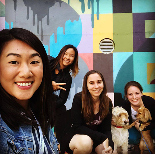 Danielle Detering '13 (third from the left) in front the YouTube office mural at Google.