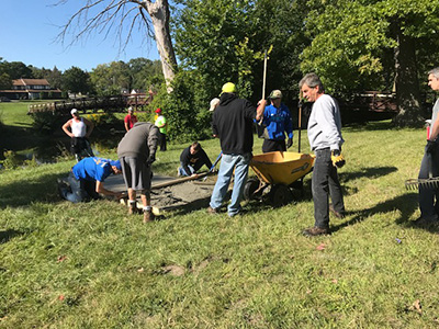 Kettering University students participate in Service Saturday to beautify parts of Flint and help create a disc golf course.