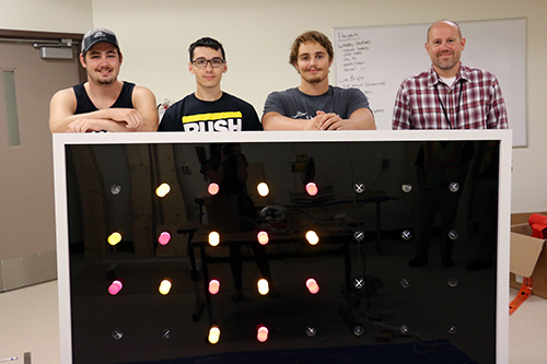 Kettering University students show finished Lite Brite to school officials