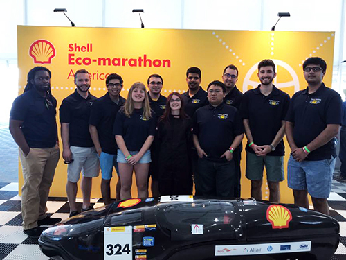 Kettering's Shell Eco-marathon team poses in front of their vehicle.
