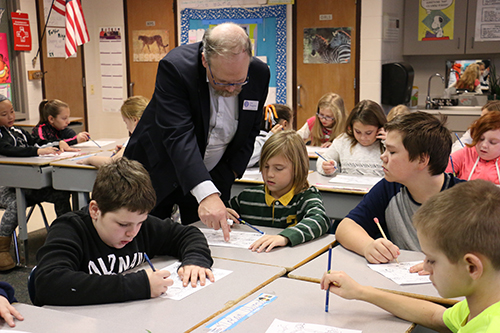Dr. Jim Huggins working with students at Tomek Elementary in Fenton.