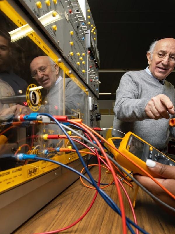 Students work under the guidance of a professor in the Electrical Engineering Machines lab.