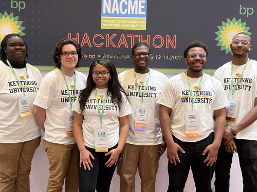 Kettering University students pose in front of the NACME Hackathon banner.