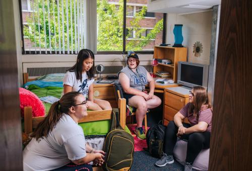 Students chat in a Thompson Hall room.