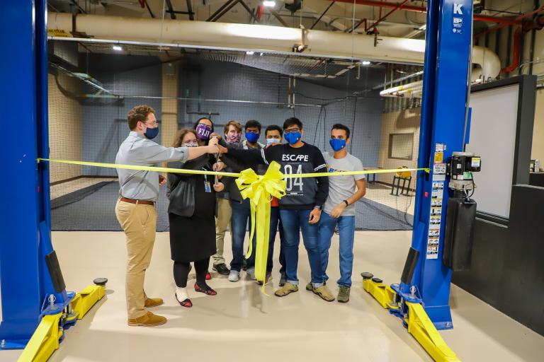 Members of the Kettering University AutoDrive team cut the ribbon for the grand re-opening of the AutoDrive lab.