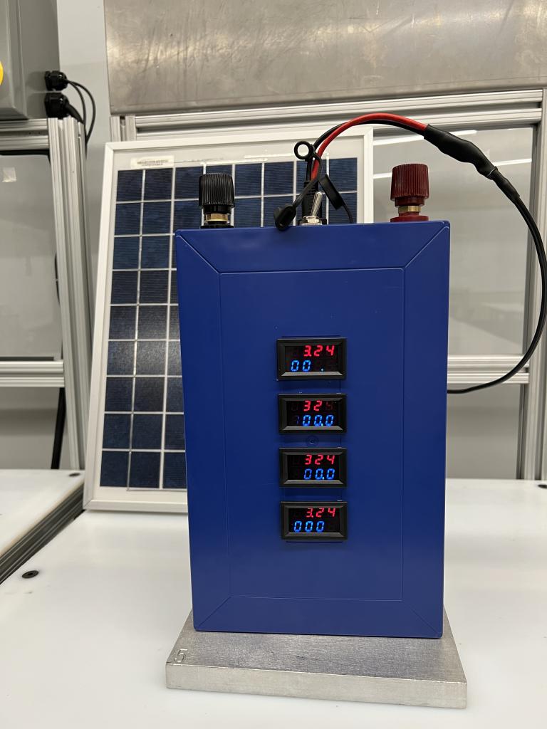 A blue Battery Management System (BMS) connected to a solar panel.