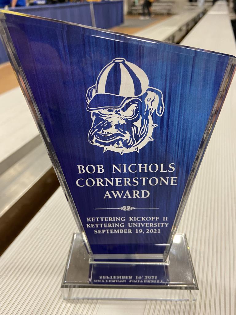 Blue glass trophy with a bulldog on it and Bob Nichols Cornerstone Award