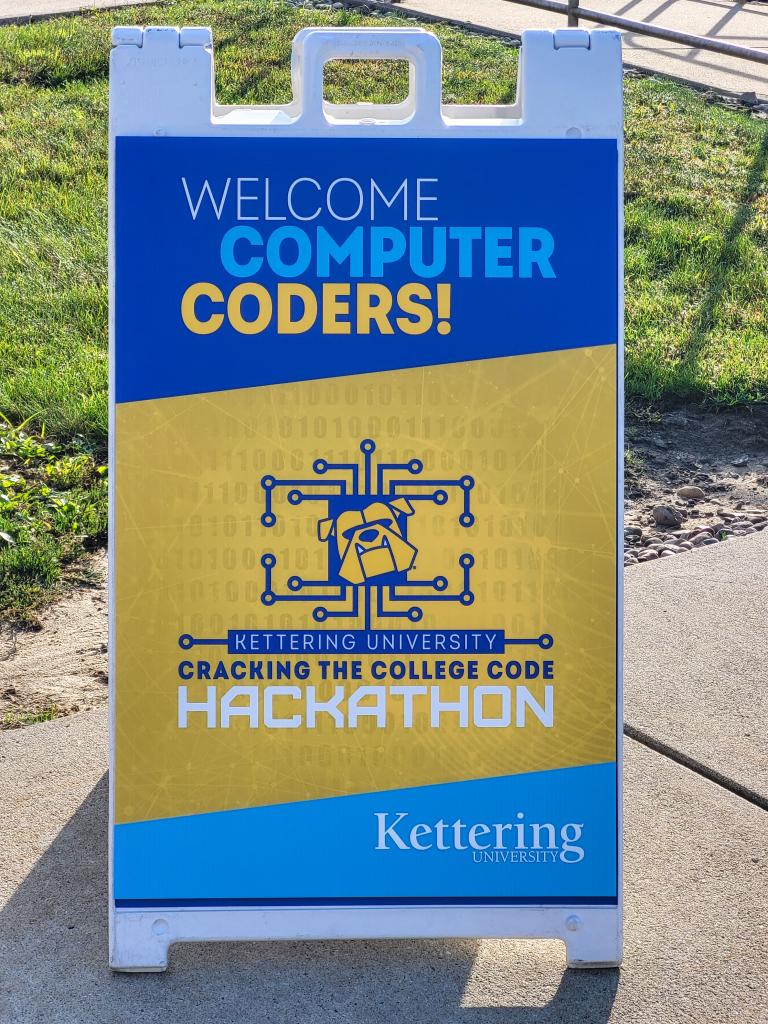 A sign outside of Kettering University that reads, "Welcome Computer Coders!"