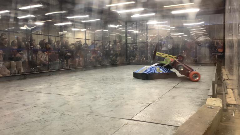 Mad Dog, Kettering University's combat robot, participates in a battle and flips another robot.