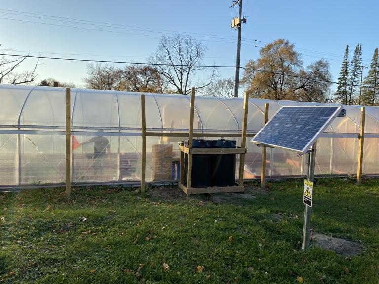 A hoop house with solar panels to power it was built by the Kettering University Sage Club.