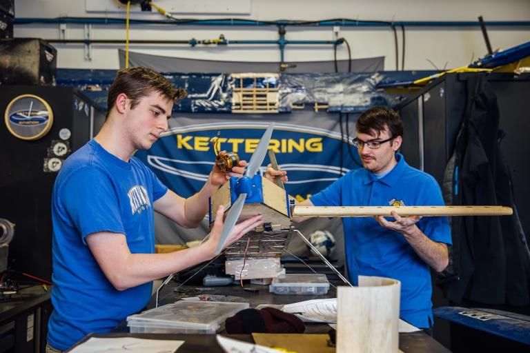 Two Kettering University students building a propeller. 