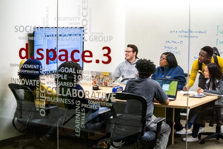 Students work in a group in a campus dspace