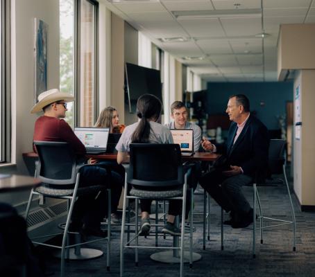 A view of MBA students discussing concepts with a Professor at Kettering University 