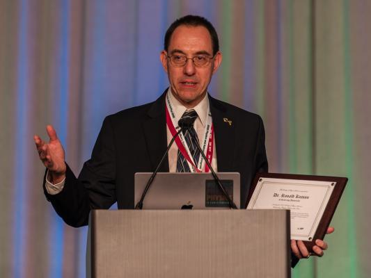 Kettering Faculty Member Dr. Ron Kumon receiving the SPS Outstanding Chapter Advisor Award.