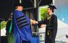 President Robert K. McMahan awards a degree