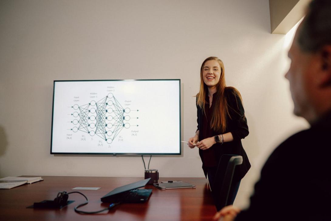 Kettering MBA student presenting a diagram on a screen during a classroom meeting