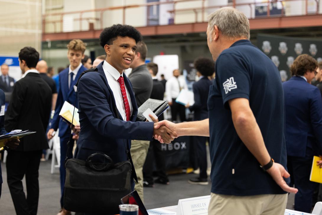 Student shaking employers hand