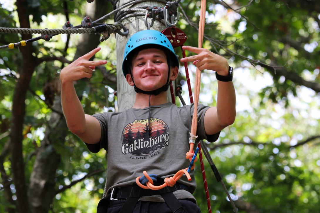 Student rope climbing during Camp Compass