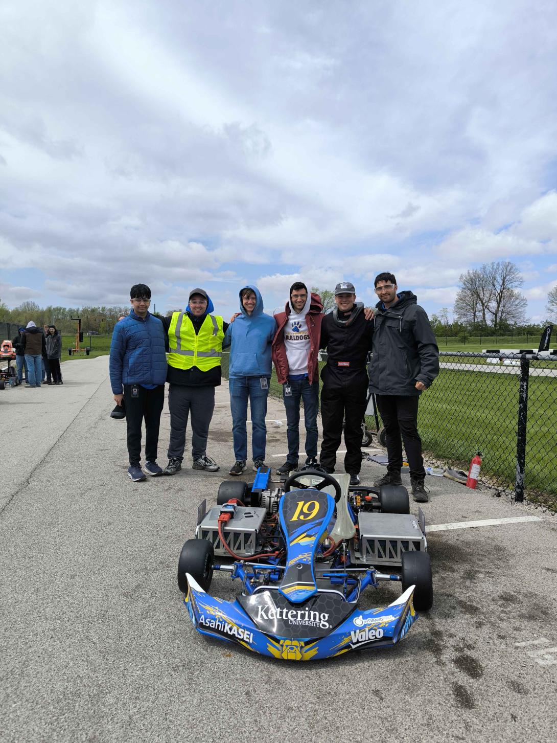 ev kartz Facutly advisors standing by the new ev kartz car